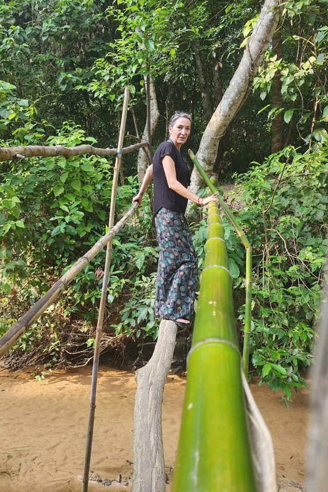 Woman standing on bamboo in Bangladesh